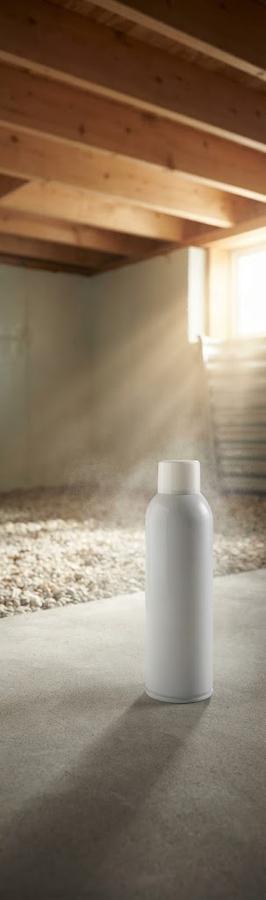 Aerosol fogger cans staged on drop cloths in adjacent empty rooms